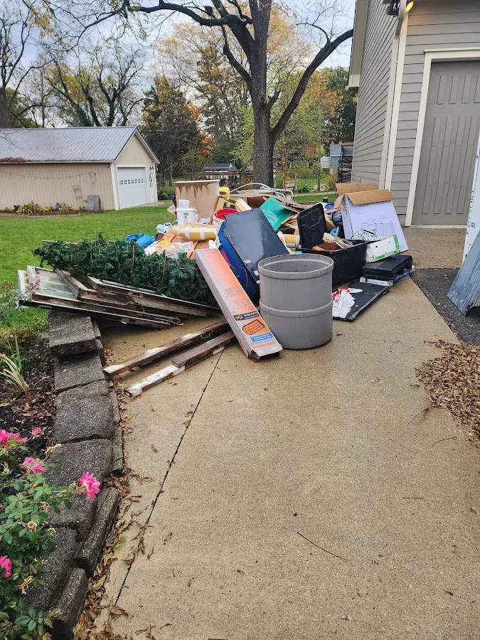 Dumpster being loaded with debris for Estate Cleanout Dumpster Rental in Chanhassen